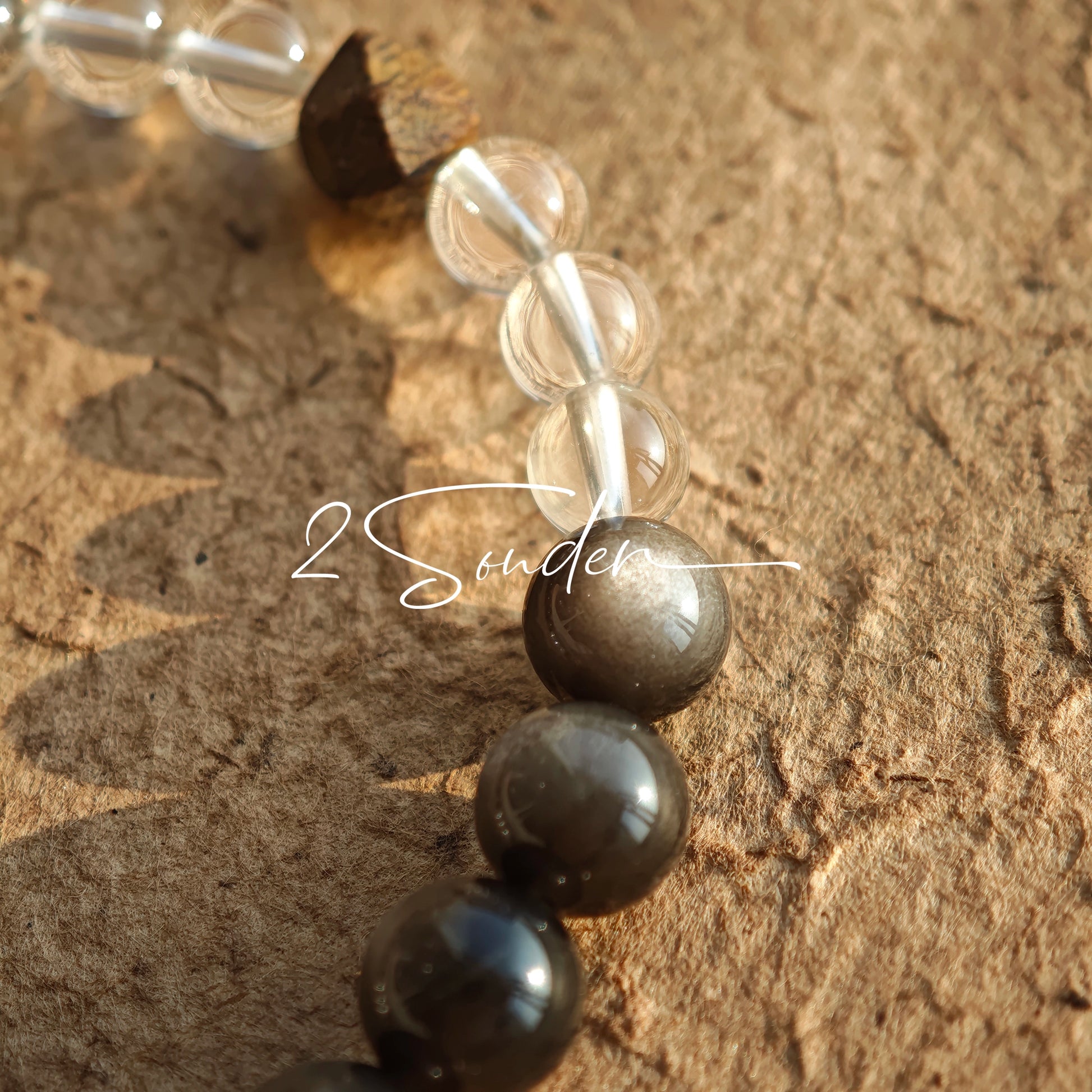 This bracelet combines genuine Silver Obsidian (look for the subtle silver sheen under light), high-clarity White Quartz, and Real Agarwood. Unlike synthetic imitations, our Agarwood carries a faint, natural woody scent that deepens over time. Plus, there is an Agate ring in the bracelet, which adds a touch of classical beauty. It feels grounded and real on your skin.