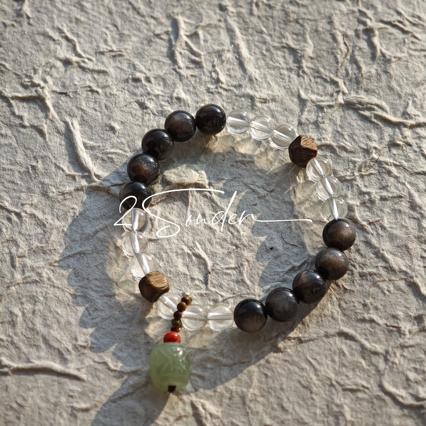 This bracelet combines genuine Silver Obsidian (look for the subtle silver sheen under light), high-clarity White Quartz, and Real Agarwood. Unlike synthetic imitations, our Agarwood carries a faint, natural woody scent that deepens over time. Plus, there is an Agate ring in the bracelet, which adds a touch of classical beauty. It feels grounded and real on your skin.