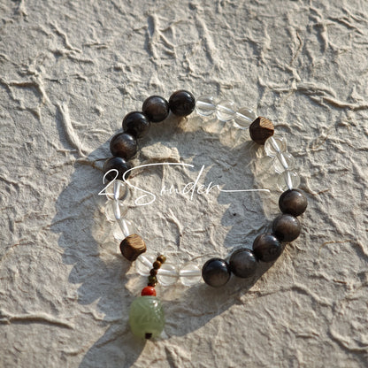 This bracelet combines genuine Silver Obsidian (look for the subtle silver sheen under light), high-clarity White Quartz, and Real Agarwood. Unlike synthetic imitations, our Agarwood carries a faint, natural woody scent that deepens over time. Plus, there is an Agate ring in the bracelet, which adds a touch of classical beauty. It feels grounded and real on your skin.