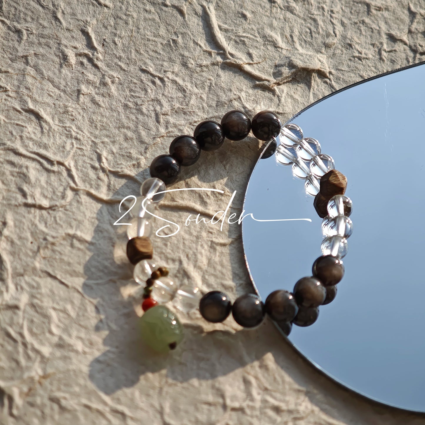 This bracelet combines genuine Silver Obsidian (look for the subtle silver sheen under light), high-clarity White Quartz, and Real Agarwood. Unlike synthetic imitations, our Agarwood carries a faint, natural woody scent that deepens over time. Plus, there is an Agate ring in the bracelet, which adds a touch of classical beauty. It feels grounded and real on your skin.