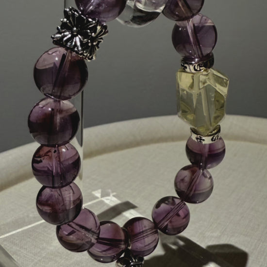 This is a crystal bracelet that consists of amethyst, citrine and chrome hearts spacers.