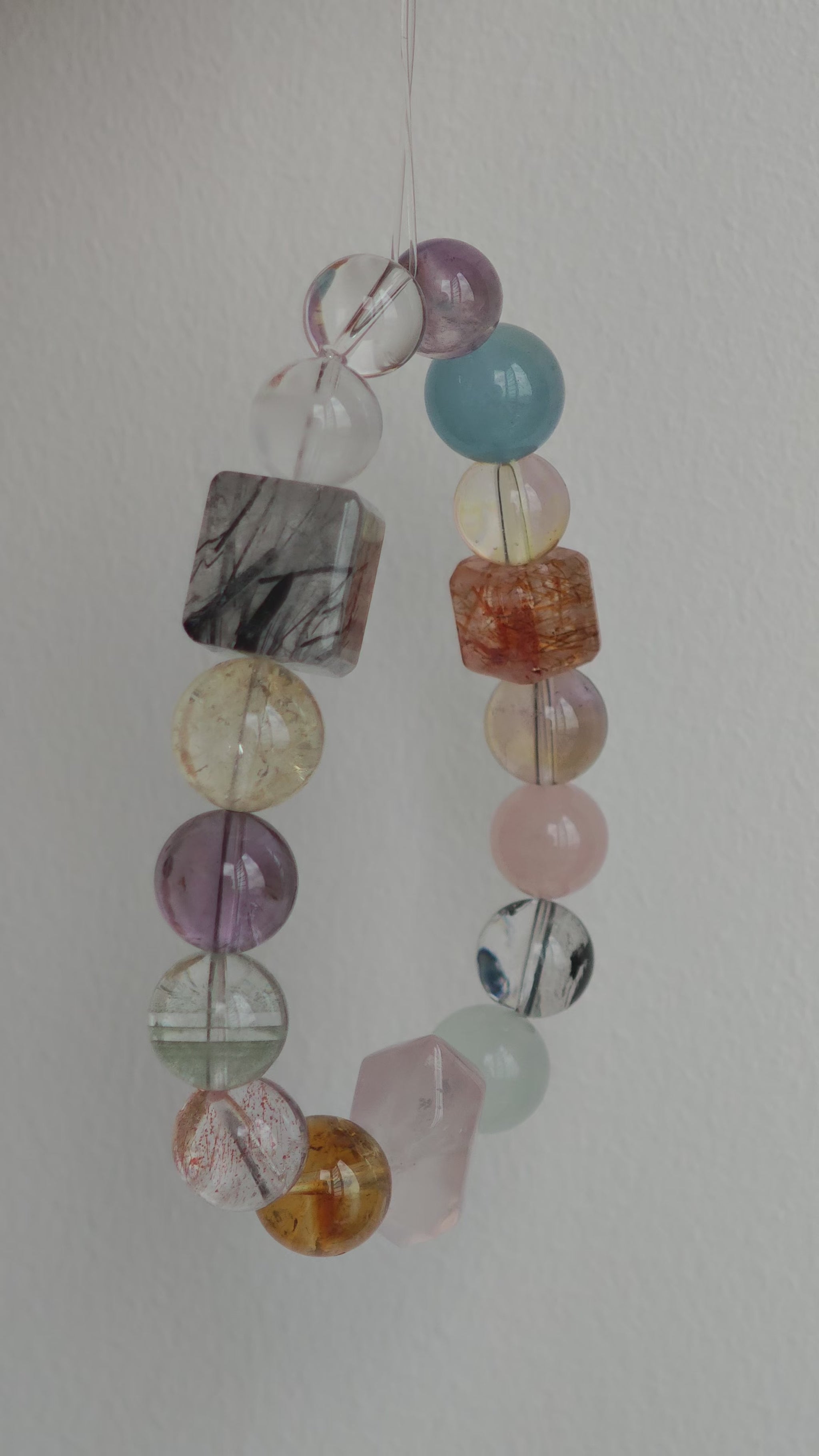 This multi gemstone bracelet features aquamarine, amethyst, strawberry quartz, rose quartz, green phantom quartz, and black rutilated quartz.