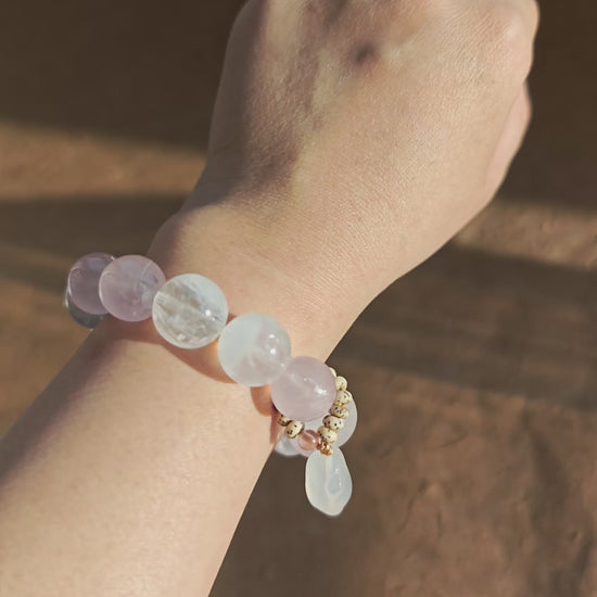 Hand-strung Rose Quartz, White Phantom Quartz, and an agate bunny slider make this crystal bracelet.