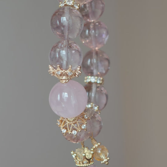 This is a bracelet featuring high-clarity amethyst, rose quartz, and citrine. It's an elegant look of pure peace.