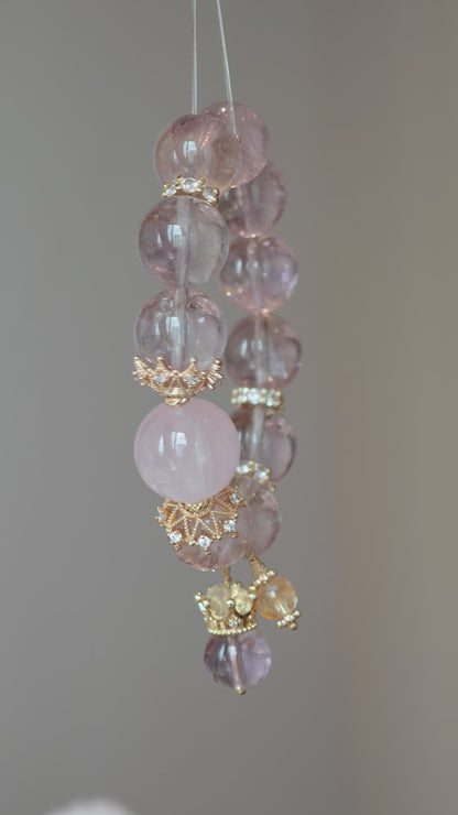 This is a bracelet featuring high-clarity amethyst, rose quartz, and citrine. It's an elegant look of pure peace.