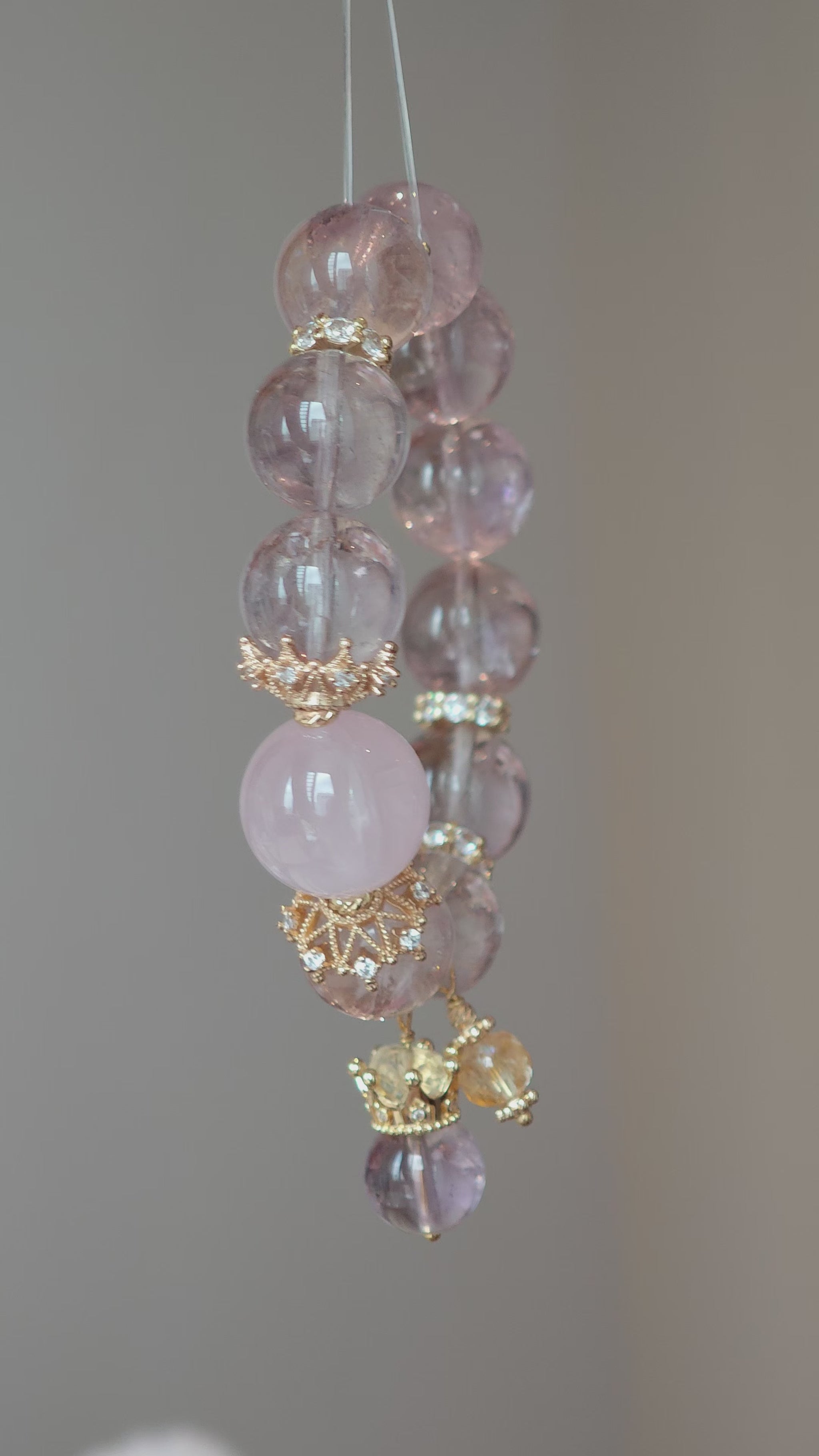 This is a bracelet featuring high-clarity amethyst, rose quartz, and citrine. It's an elegant look of pure peace.